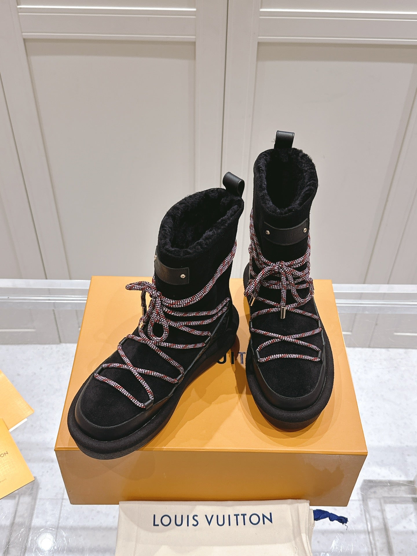 LOUIS VUITTON ASPEN PLATFORM ANKLE BOOT IN BLACK MONOGRAM DEBOSSED SUEDE AND SHEARLING