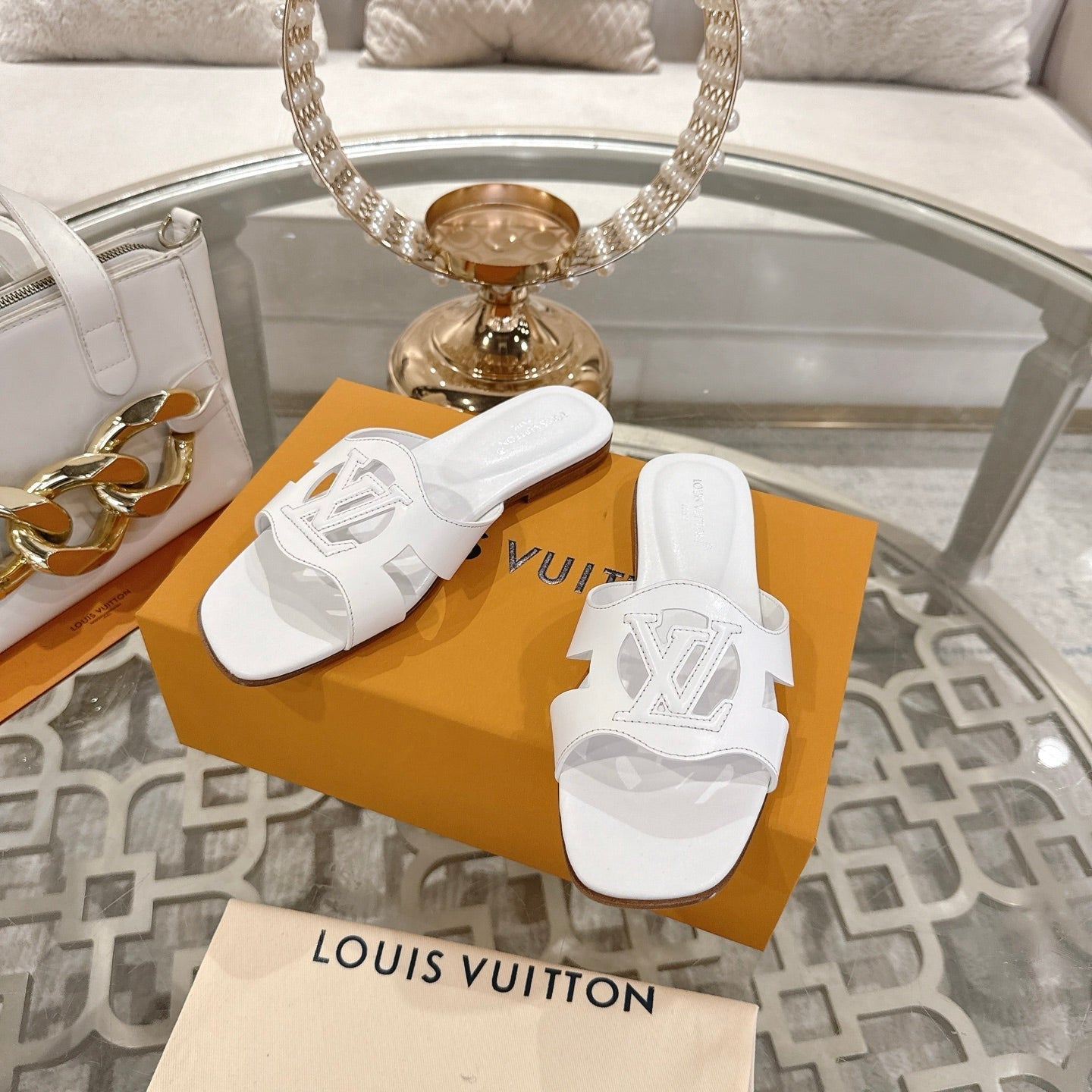 LOUIS VUITTON ISOLA FLAT SLIDE IN WHITE CALFSKIN
