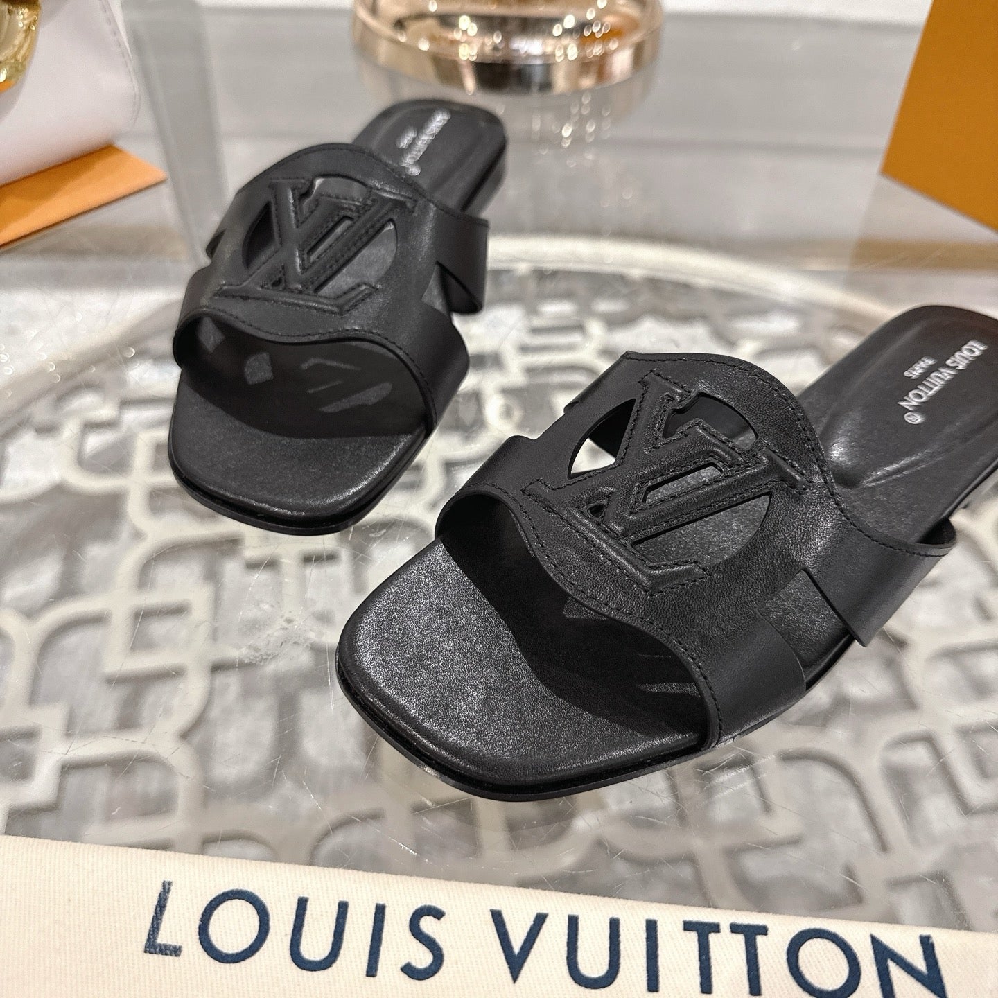 LOUIS VUITTON ISOLA FLAT SLIDE IN BLACK CALFSKIN
