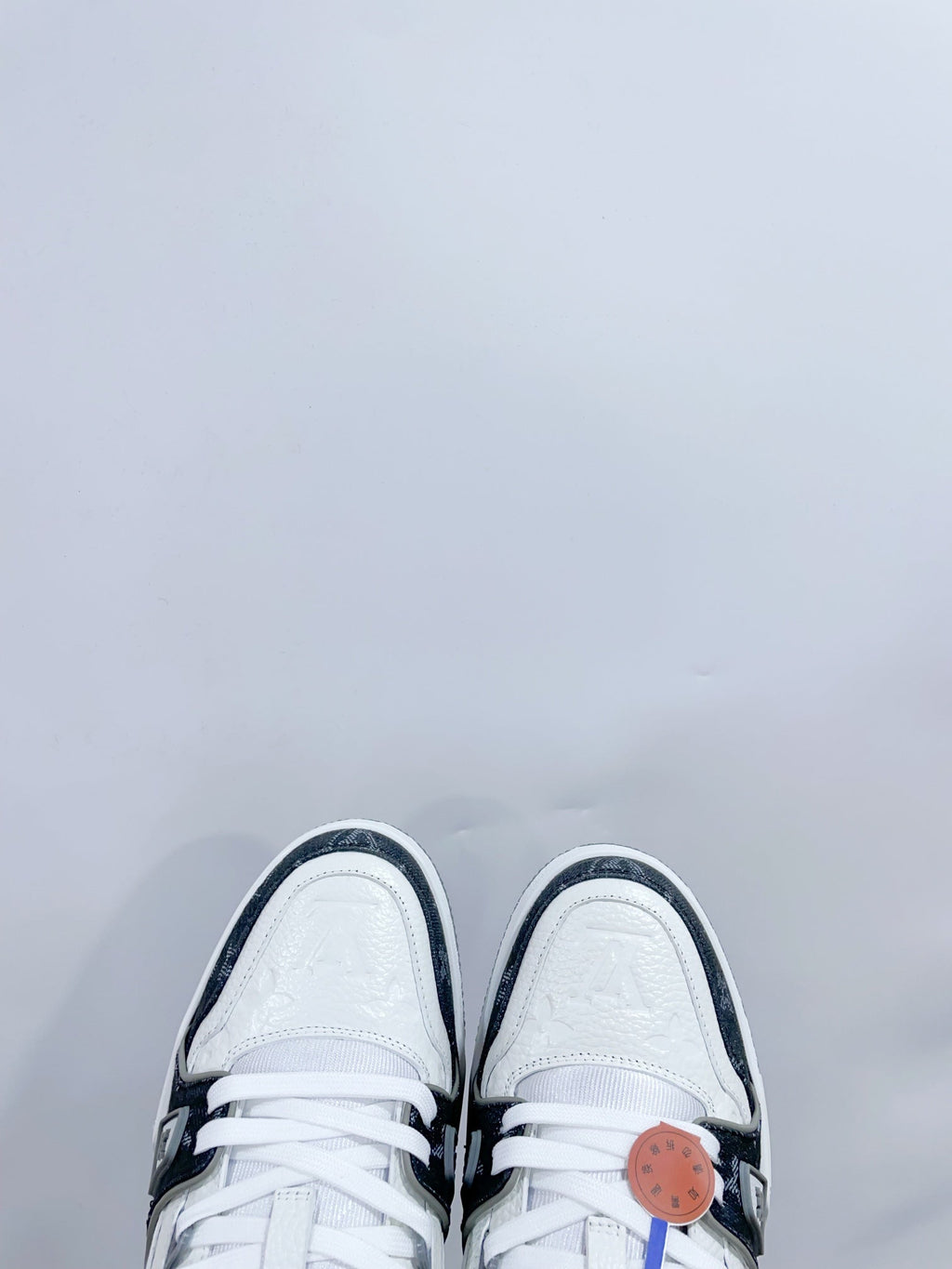LOUIS VUITTON LV TRAINER SNEAKER IN WHITE CALFSKIN AND BLACK MONOGRAM DENIM